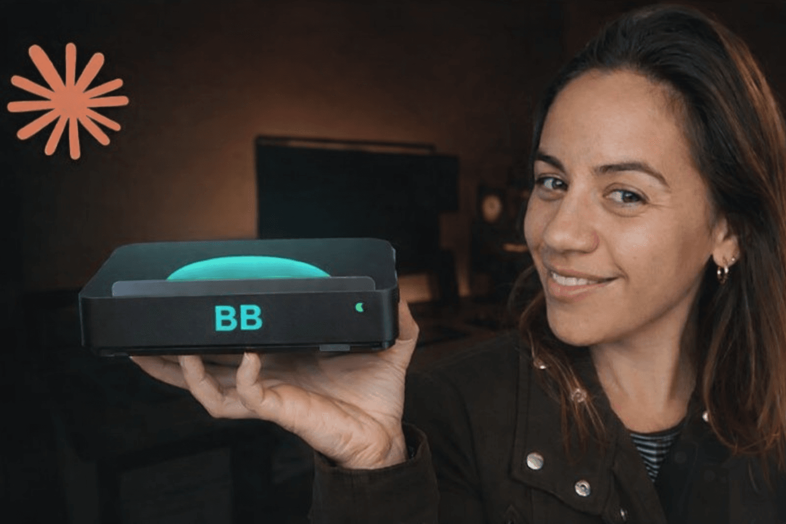 Danielle holding the Billy Bot — a compact AI mini-PC with glowing teal BB logo
